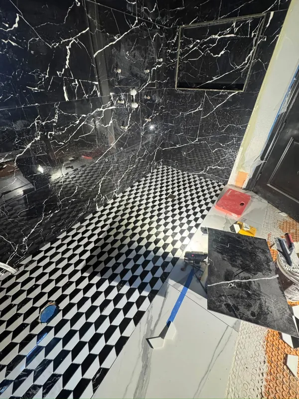 Dark shower wall tile and patterned floor