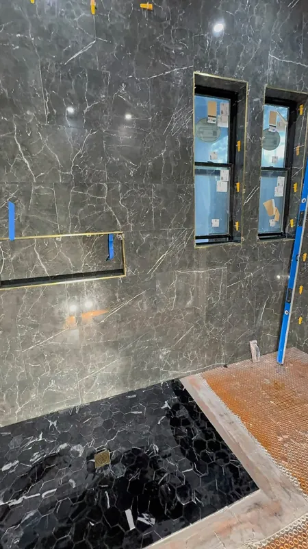 Dark shower tile with recessed niche