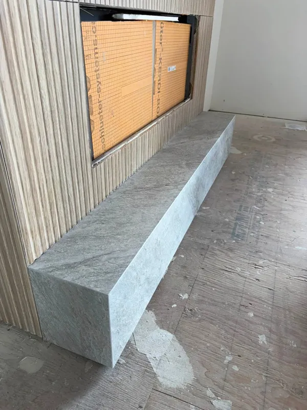 Long tiled bench beneath a window