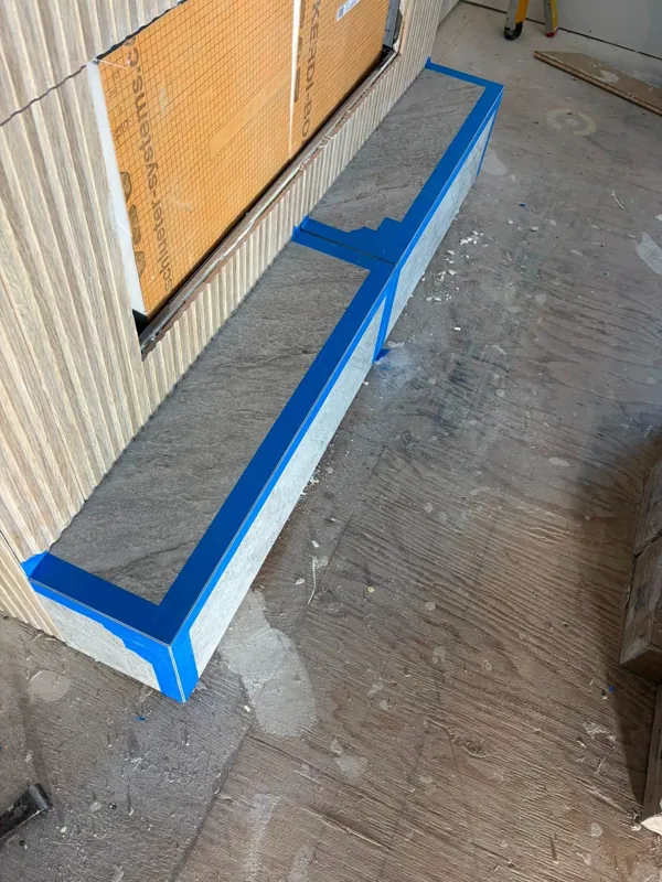 Tiled bench and surrounding floor during construction