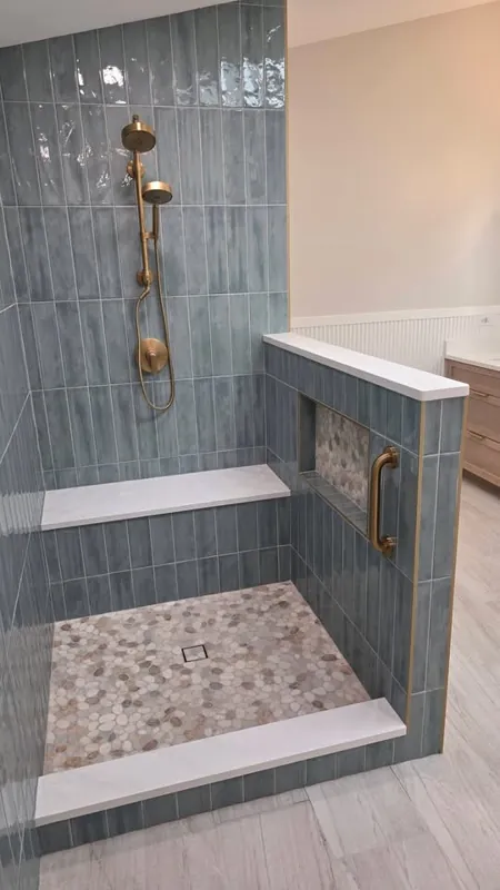 Bathroom vanity beside a tiled walk-in shower
