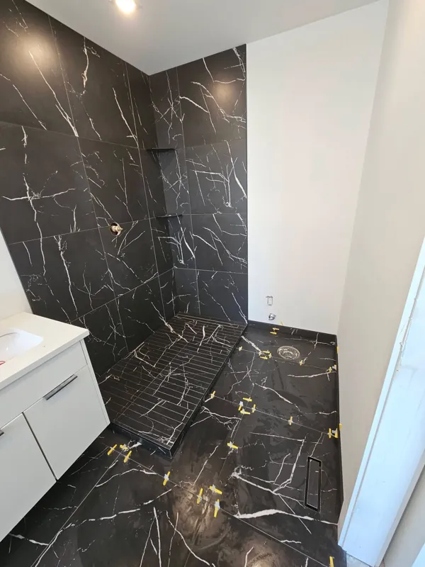 Dark marble-look shower wall tile
