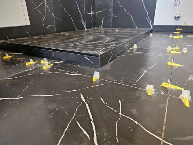 Dark large-format tile during installation