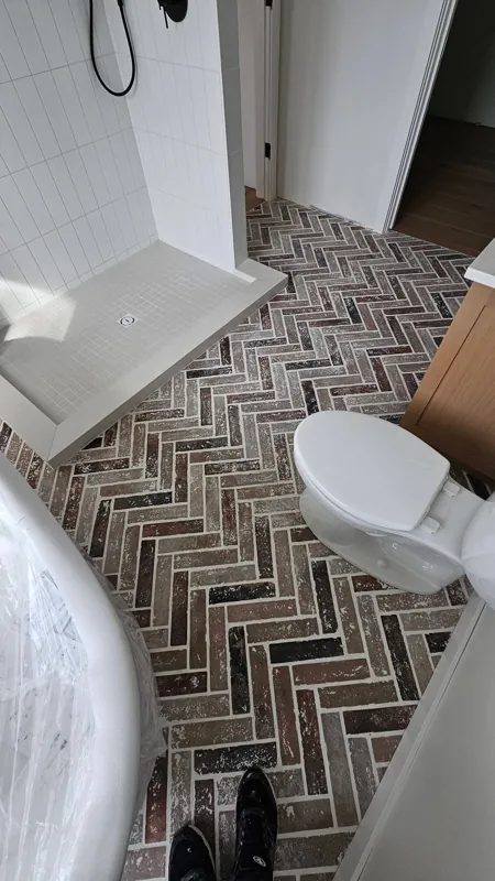 Patterned bathroom floor beside a vanity